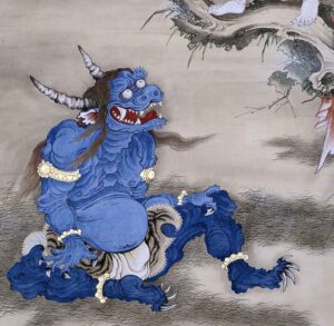 A blue, muscular creature with horns and a fierce expression sits on the ground, adorned with golden wristbands. Its body is heavily outlined and textured, showcasing exaggerated features like a large belly and sharp claws. The background is a muted beige with faint, swirling patterns.