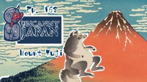 A colorful illustration featuring Mount Fuji in the background, with a stylized logo for 'Uncanny Japan' and an animated creature reminiscent of a raccoon in the foreground. The logo includes the episode number 'Ep. 168' and the text 'Mount Fuji'.